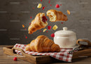 Fresh croissants with raspberry jam and butter on tray