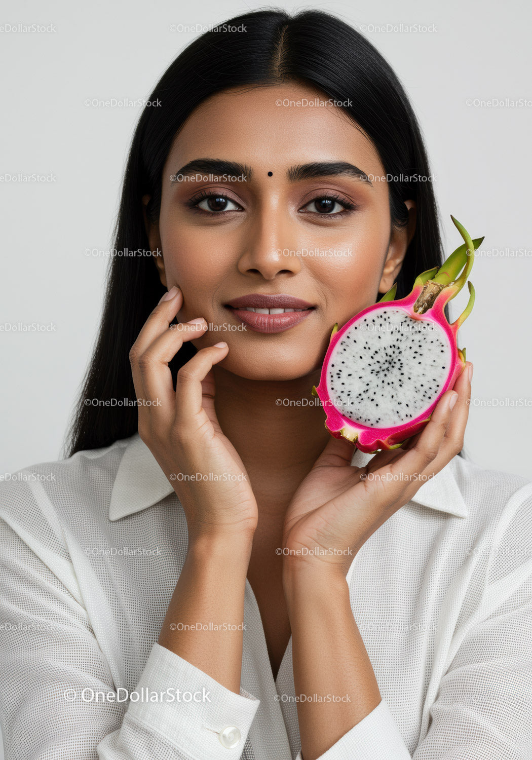 Close-Up of Smiling Woman with Fresh Dragon Fruit in a Bright Studio