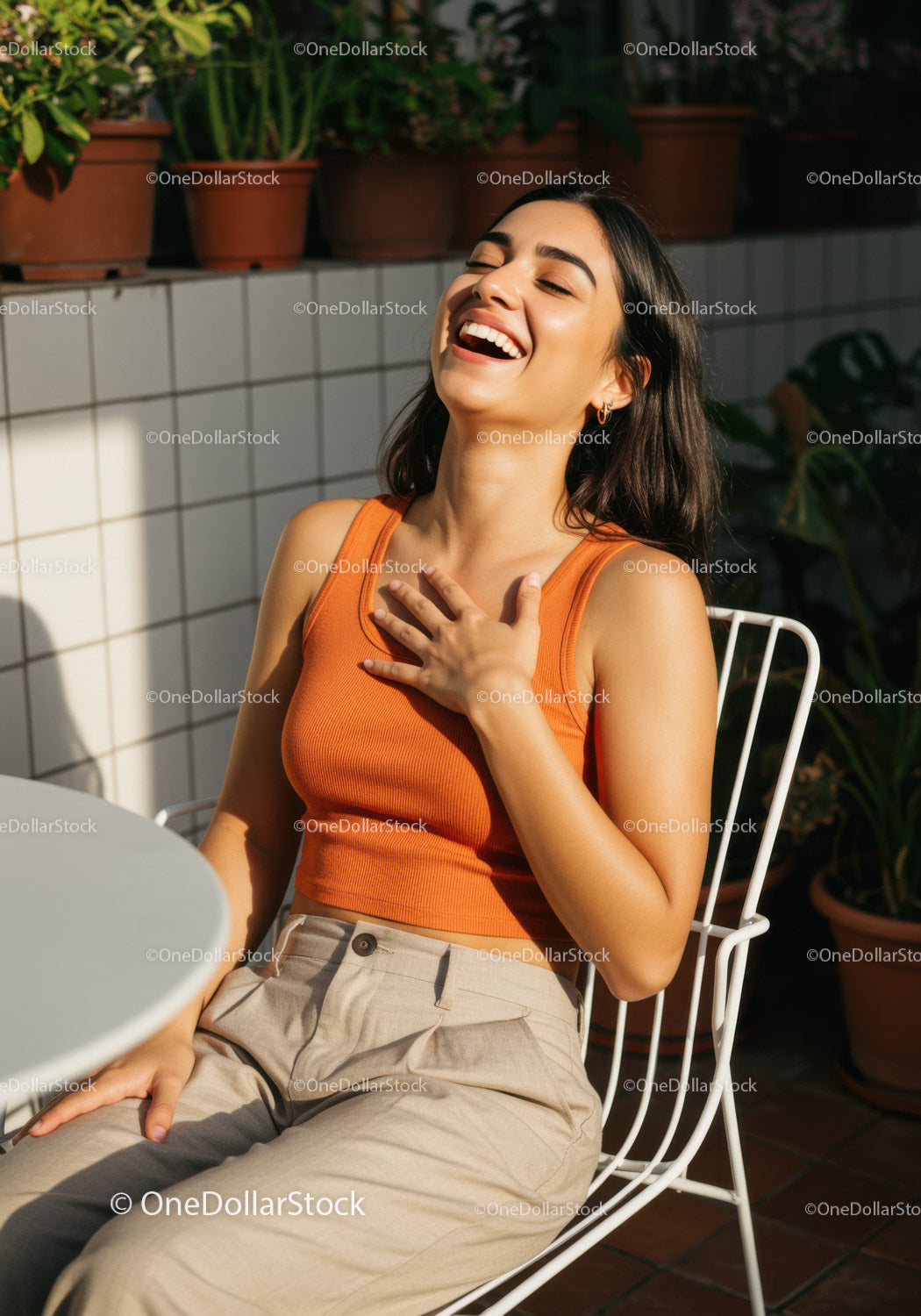 Joyful Woman Enjoying Sunny Day in Casual Outfit at Outdoor Cafe