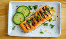 Grilled Salmon with Cucumber and Fresh Parsley on White Plate