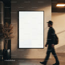 Man walking past blank framed poster in modern hallway