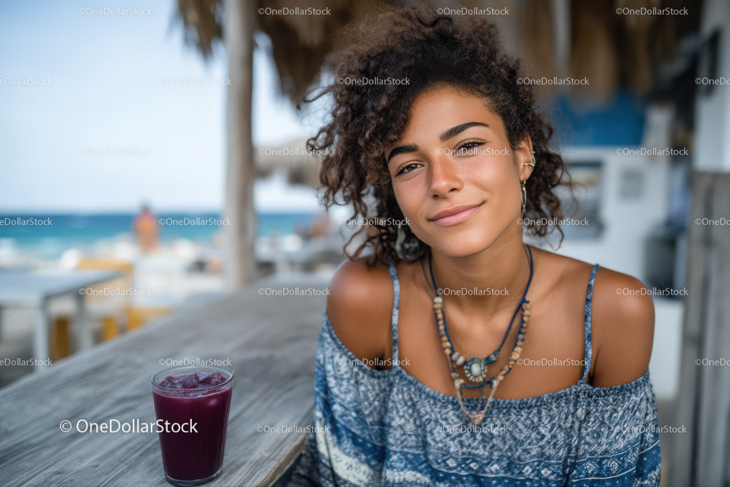 Smiling Woman Relaxing at Beachside Cafe with Drink