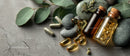 Herbal Supplements and Natural Medicine Bottles with Green Leaves and Rocks