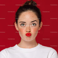 Expressive Woman with Freckles and Red Lips on Red Background