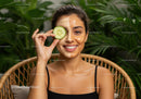 Woman with Facial Mask and Cucumber Slice in Tropical Setting