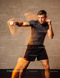 Focused boxer training powerful punch technique indoors