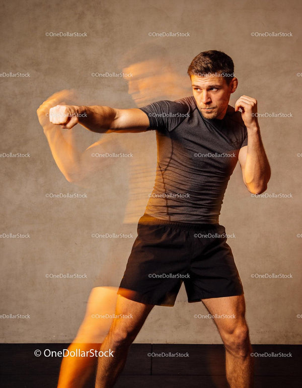 Focused boxer training powerful punch technique indoors