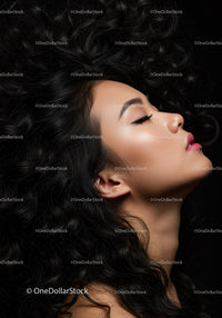 Profile of serene woman with curly hair and closed eyes