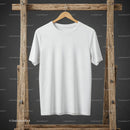 Plain white t shirt hanging on rustic wooden rack
