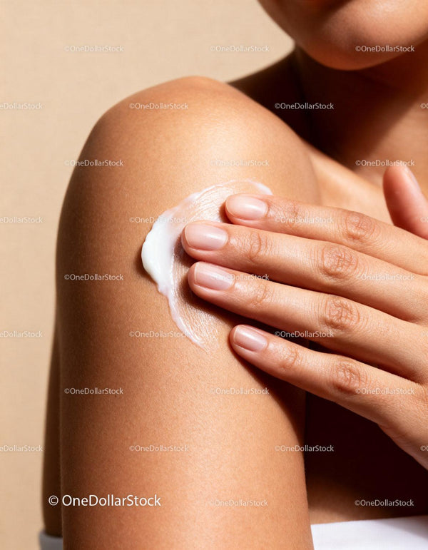 Woman applying moisturizing cream on smooth shoulder