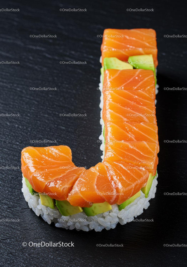 Sushi roll shaped as letter J with fresh salmon and avocado