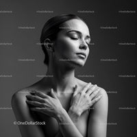 Serene woman embracing herself in soft light