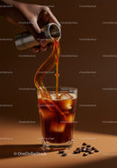 Pouring cold brew coffee over ice in clear glass