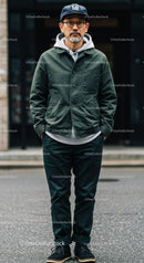 Stylish Man in Denim Jacket and Cap Standing on City Street
