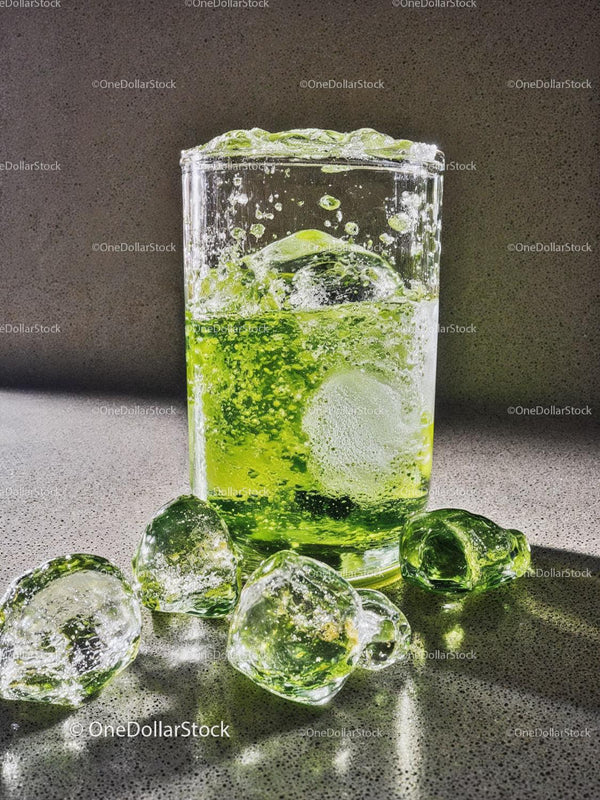 Refreshing Green Drink with Ice Cubes in Glass