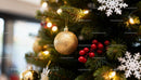 Golden bauble and festive decorations on Christmas tree