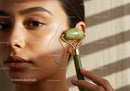 Close-up of a woman receiving facial with jade roller and eye patch