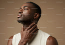 Portrait of a Young Man Applying Face Moisturizer with Smooth Skin