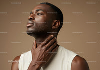 Portrait of a Young Man Applying Face Moisturizer with Smooth Skin