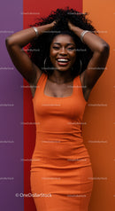 Happy Woman in Vibrant Orange Dress with Curly Hair on Colorful Background