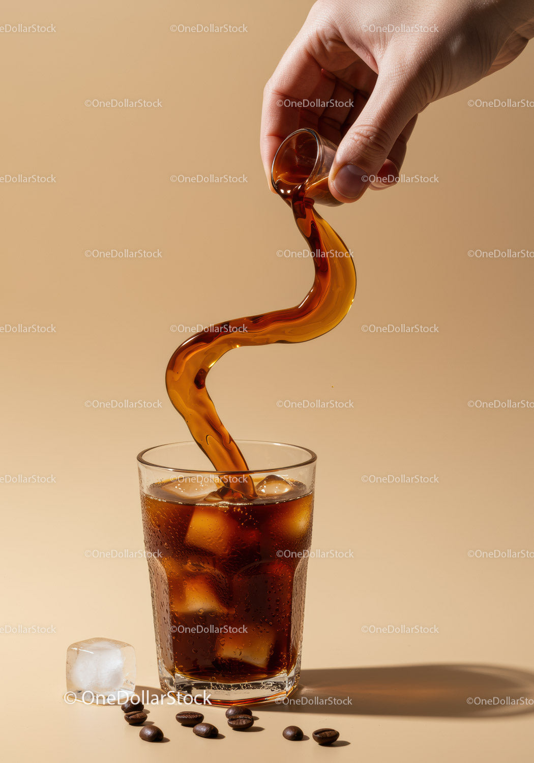 Pouring iced coffee with ice cubes and coffee beans