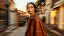 Chic Woman in Brown Coat Walking Through Busy City Street