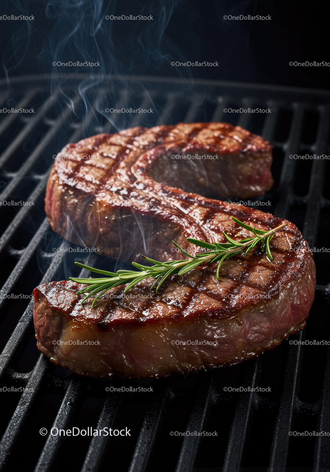 Juicy grilled ribeye steak with fresh rosemary on barbecue