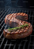 Juicy grilled ribeye steak with fresh rosemary on barbecue