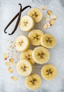 Frozen banana slices with vanilla and almond flakes on ice