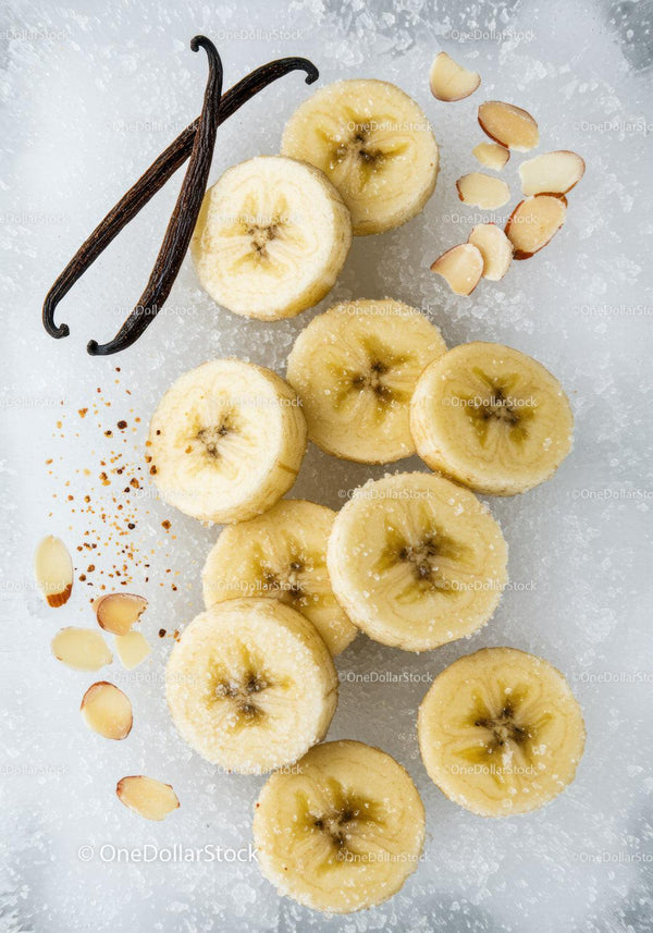 Frozen banana slices with vanilla and almond flakes on ice