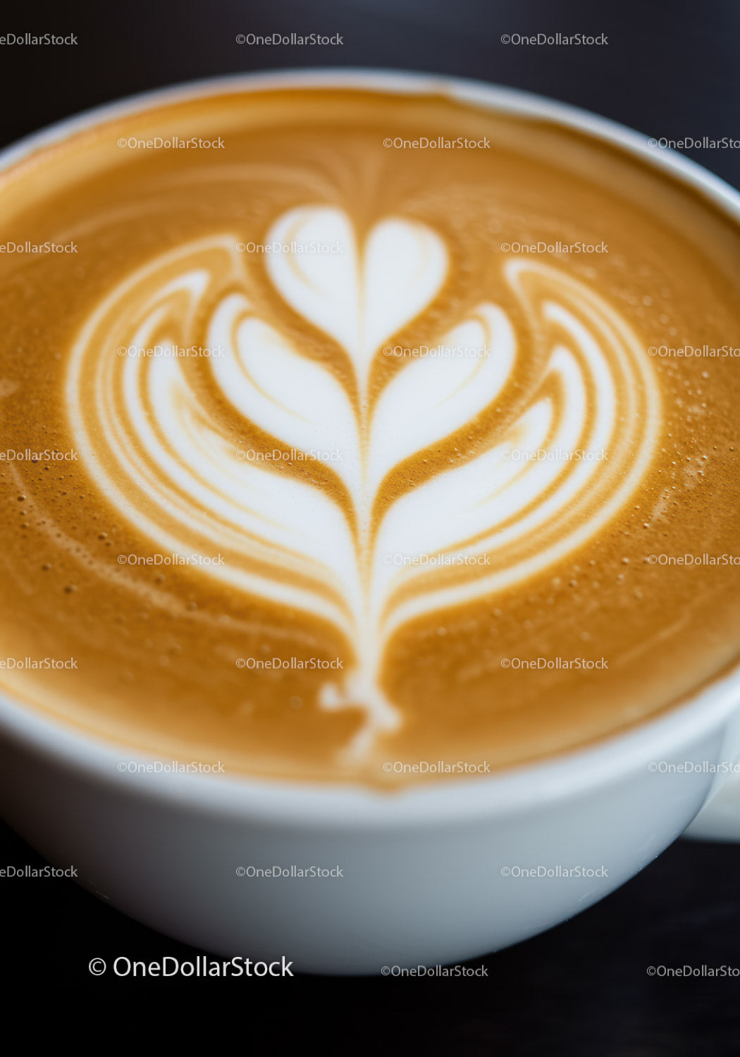 Close up of creamy latte art in white ceramic cup