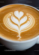 Close up of creamy latte art in white ceramic cup