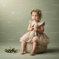 Toddler girl in floral crown holding knitted bunny