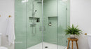 Modern bathroom with glass shower and green tiles