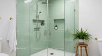 Modern bathroom with glass shower and green tiles