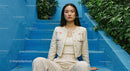 Chic Young Woman Sitting on Blue Stairs in Urban Environment