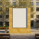Empty urban billboard framed by stone wall in plaza