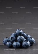 Fresh blueberries with water droplets on dark surface