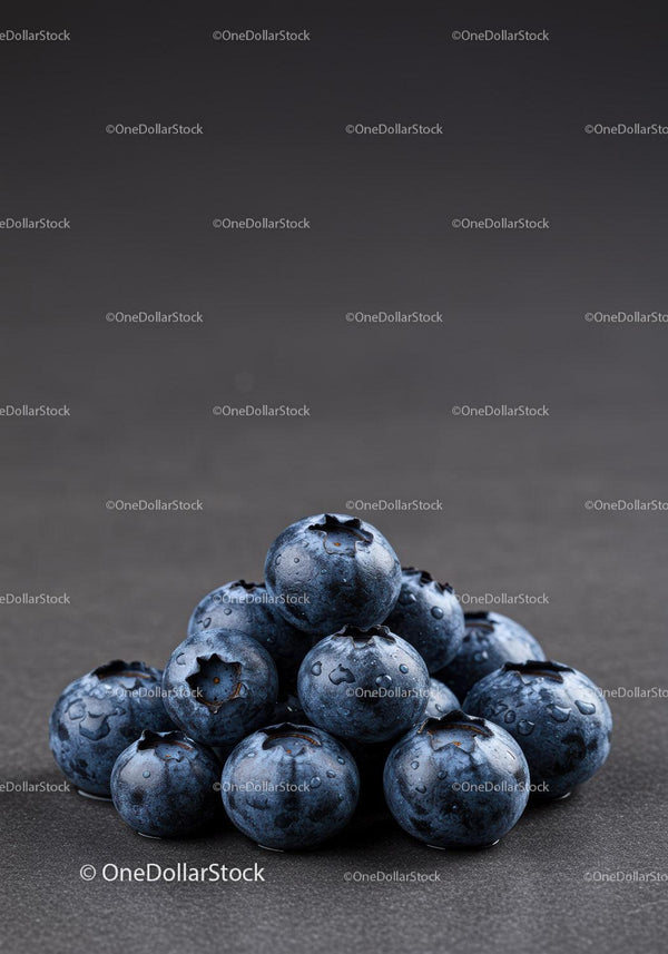 Fresh blueberries with water droplets on dark surface