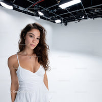 Portrait of a Young Woman in White Dress in Studio with Soft Lighting