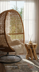 Cozy wicker hanging chair with plush throw in sunlit room