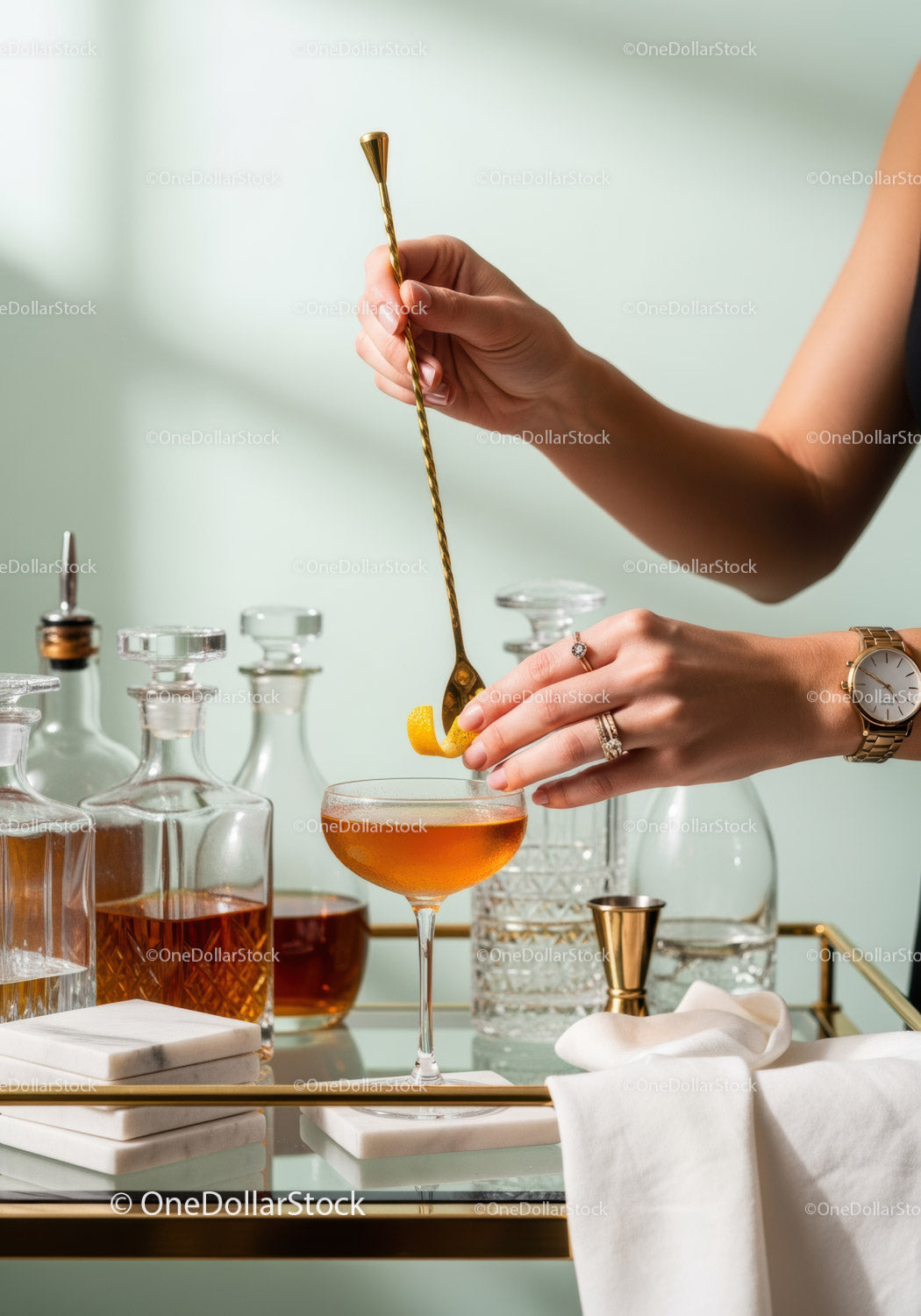 Elegant Amber Cocktail Being Mixed with Gold Stirrer in Stylish Bar