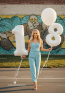 Young woman celebrating her eighteenth birthday outdoors