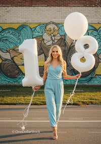 Young woman celebrating her eighteenth birthday outdoors