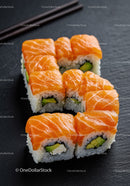 Fresh salmon sushi rolls arranged in letter S shape