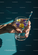 Hand Holding Glass of Floral Infused Sparkling Water