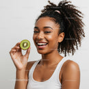 Happy Woman Holding Fresh Kiwi Fruit with Curly Hair