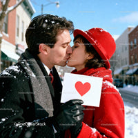 Couple sharing a romantic kiss outdoors in winter