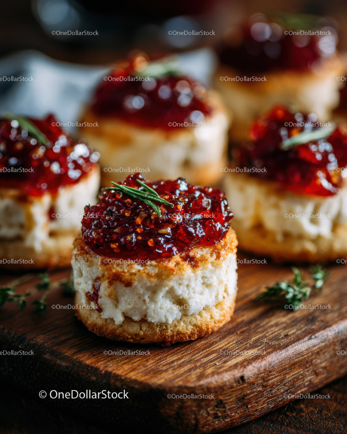 Mini Cheesecake Bites with Raspberry Jam Topping on Rustic Wooden Board