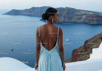 Woman in Blue Dress Overlooking Serene Ocean View